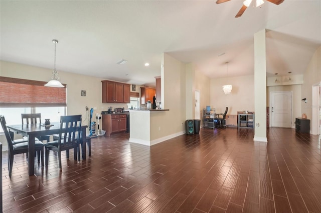 dining room featuring ceiling fan with notable chandelier