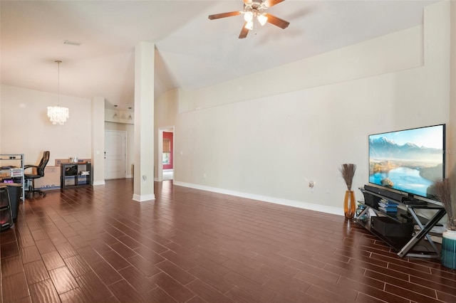 office area featuring ceiling fan with notable chandelier and vaulted ceiling