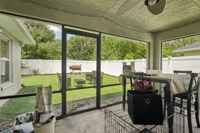 sunroom / solarium featuring ceiling fan