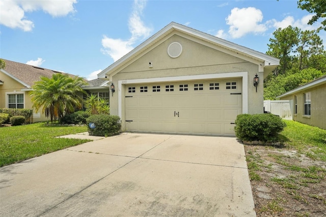 view of front of house featuring a garage and a front lawn