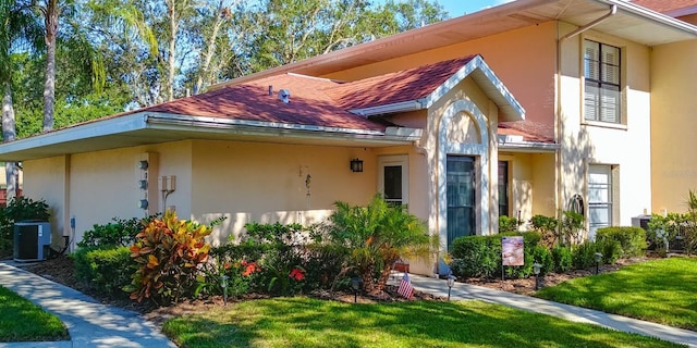 view of home's exterior featuring a lawn and cooling unit