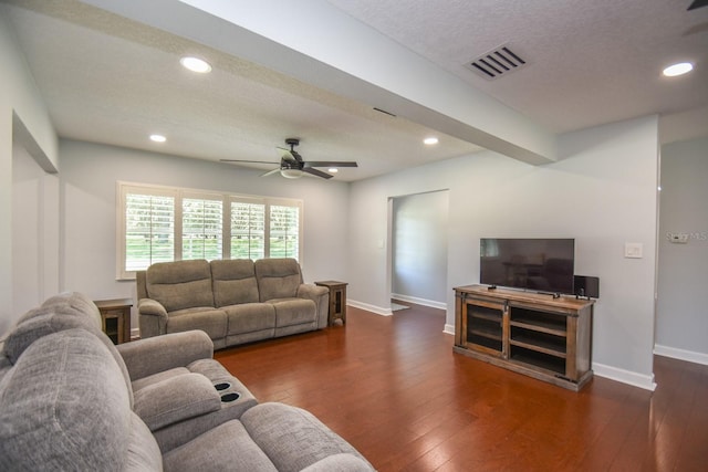 living room with dark hardwood / wood-style floors, ceiling fan, and a textured ceiling