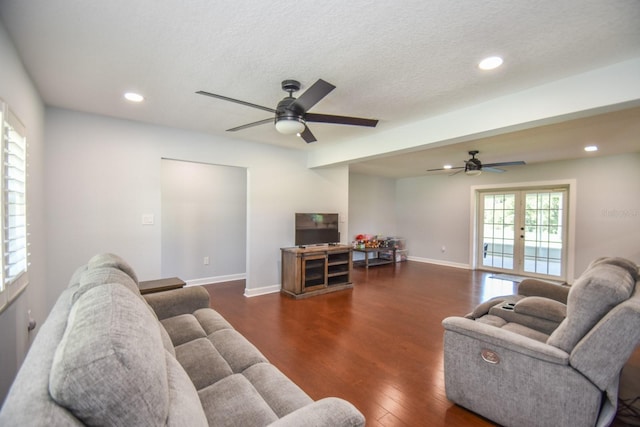 living room with ceiling fan, french doors, dark hardwood / wood-style flooring, and a textured ceiling