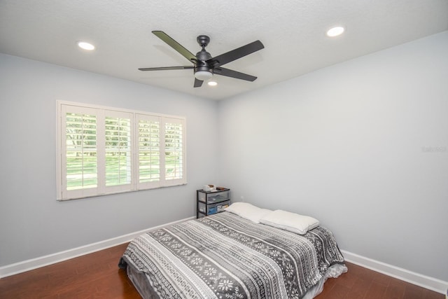 bedroom featuring dark hardwood / wood-style flooring and ceiling fan