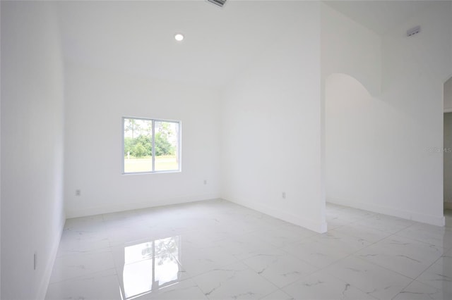 spare room featuring baseboards, recessed lighting, and marble finish floor