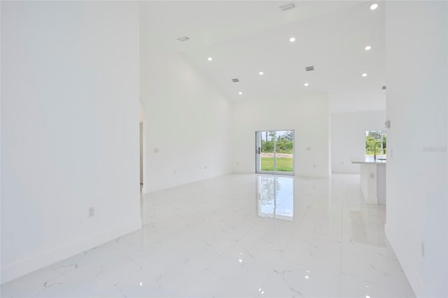 spare room with baseboards, recessed lighting, visible vents, high vaulted ceiling, and marble finish floor