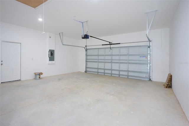 garage with electric panel and a garage door opener