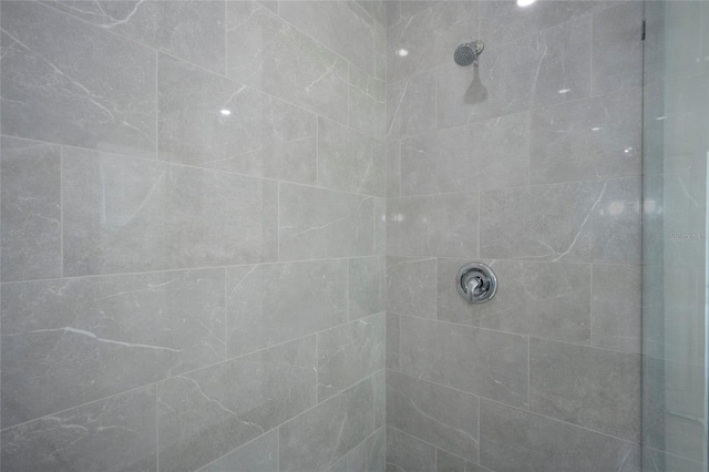 bathroom with tiled shower