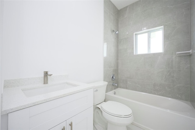 full bathroom with vanity, tiled shower / bath combo, and toilet