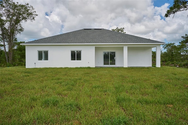 rear view of property featuring a yard