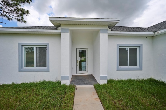 property entrance featuring stucco siding