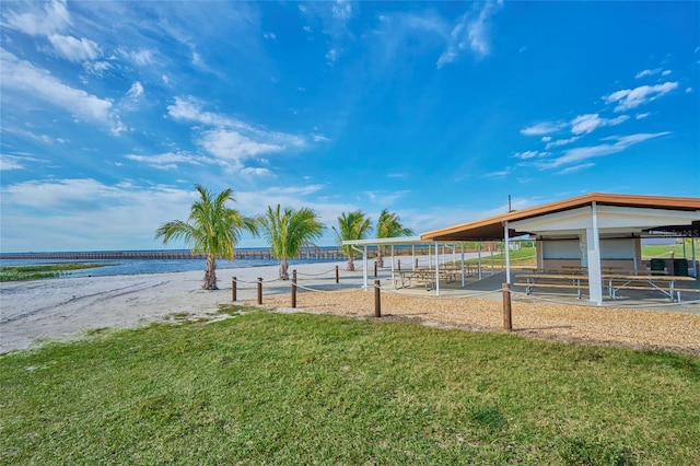 view of home's community featuring a water view and a view of the beach