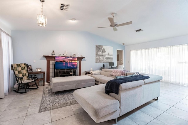 living room with a wealth of natural light, vaulted ceiling, and light tile floors