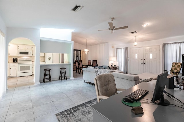 living room featuring lofted ceiling, light tile flooring, and ceiling fan with notable chandelier