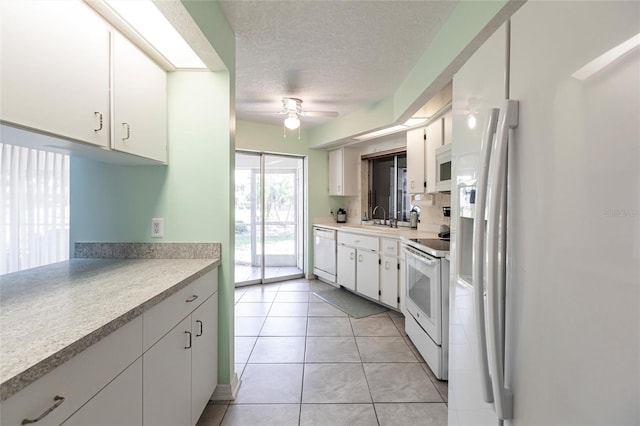 kitchen featuring ceiling fan, white appliances, a textured ceiling, light tile floors, and white cabinets