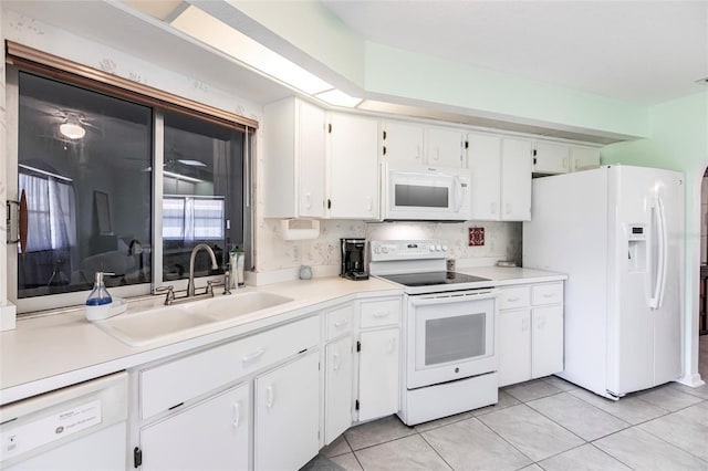 kitchen featuring white cabinetry, white appliances, backsplash, sink, and light tile floors