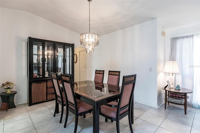 tiled dining area with a chandelier and lofted ceiling