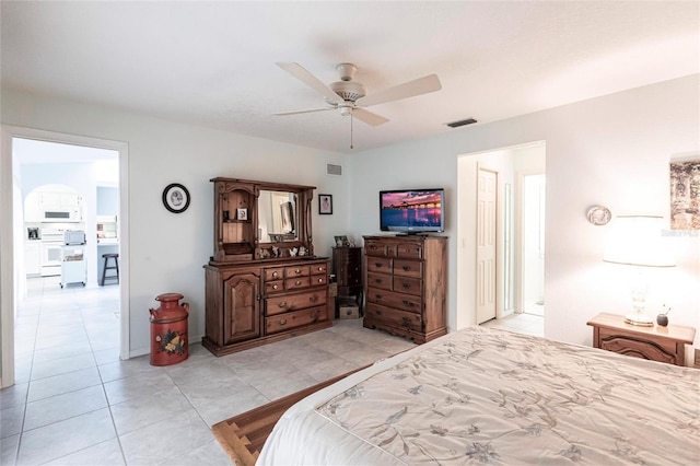 tiled bedroom with ceiling fan