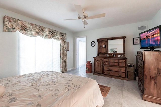 tiled bedroom featuring ceiling fan