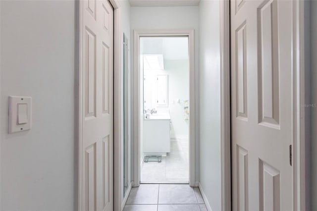 hall featuring sink and light tile floors