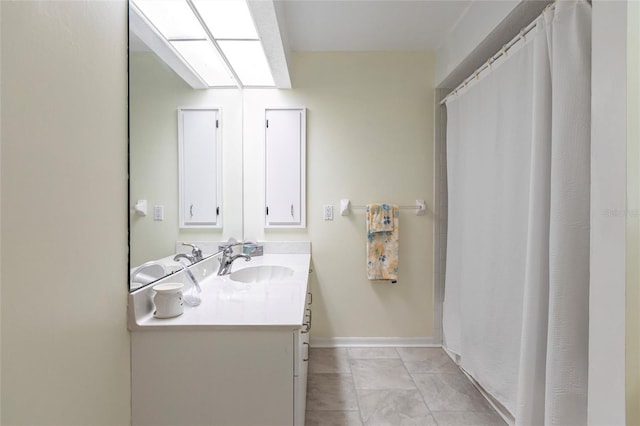 bathroom featuring tile floors and vanity with extensive cabinet space