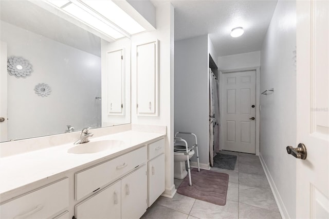 bathroom featuring tile floors, vanity, and toilet