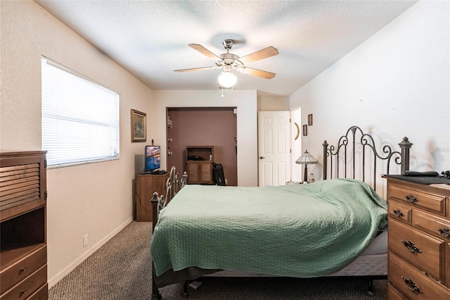 bedroom with ceiling fan, a textured ceiling, and carpet flooring