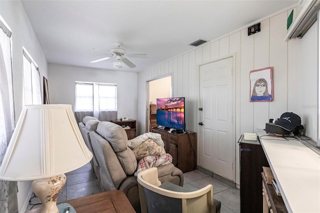 living room with ceiling fan and light tile flooring