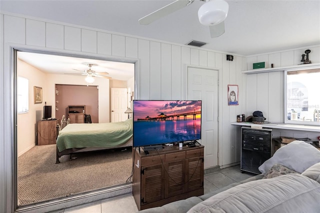 bedroom featuring beverage cooler, tile flooring, and ceiling fan