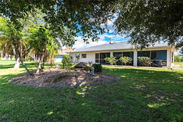 rear view of property featuring a yard