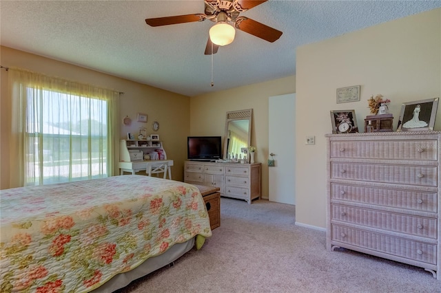 3283 Hilary Cir Unit 2C, Palm Harbor, FL 34684 - bedroom with light carpet, ceiling fan, and a textured ceiling
