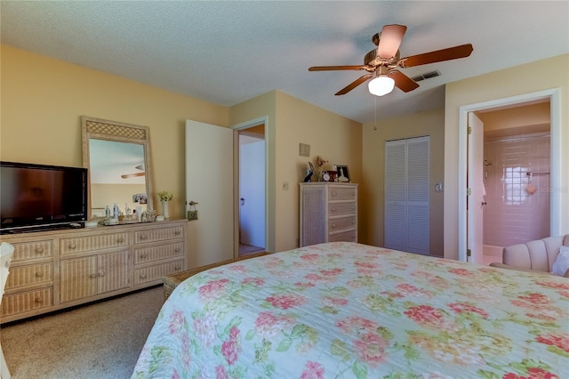 carpeted bedroom featuring a closet, ceiling fan, and a textured ceiling