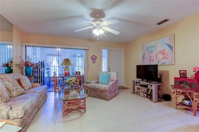 3283 Hilary Cir Unit 2C, Palm Harbor, FL 34684 - living room with a ceiling fan, light tile patterned flooring, and a textured ceiling