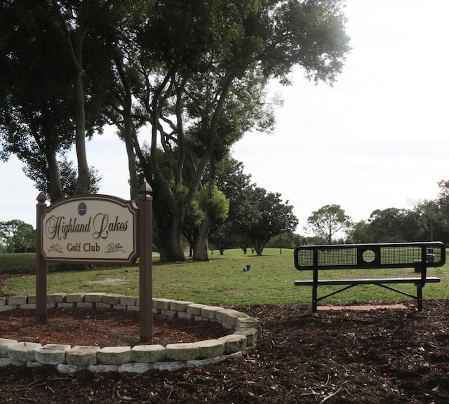 community sign featuring a lawn