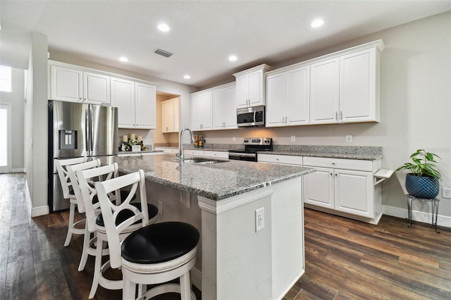 kitchen with recessed lighting, stainless steel appliances, a sink, white cabinetry, and visible vents