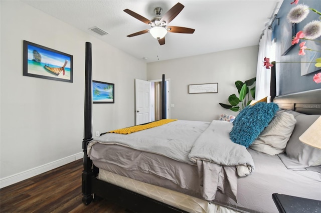 bedroom with ceiling fan and dark wood-type flooring