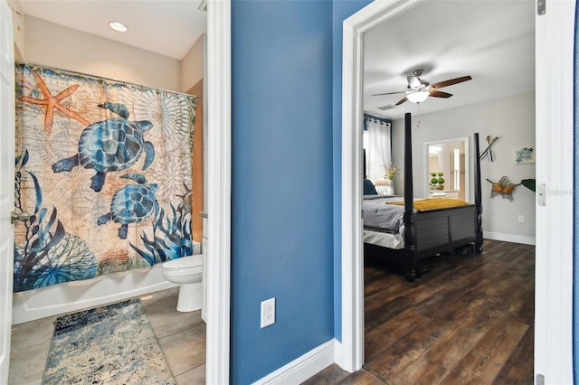 full bath featuring visible vents, baseboards, toilet, ceiling fan, and shower / bath combination with curtain