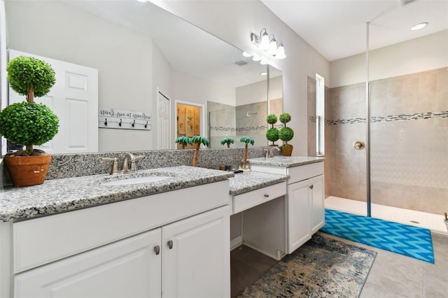 bathroom featuring tile patterned flooring, walk in shower, and vanity