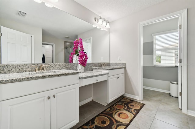 bathroom with vanity, tile patterned flooring, visible vents, and baseboards