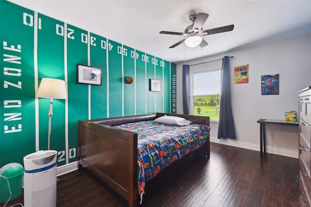 bedroom featuring a ceiling fan, a textured ceiling, baseboards, and hardwood / wood-style floors