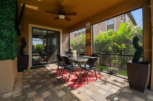 sunroom / solarium featuring ceiling fan