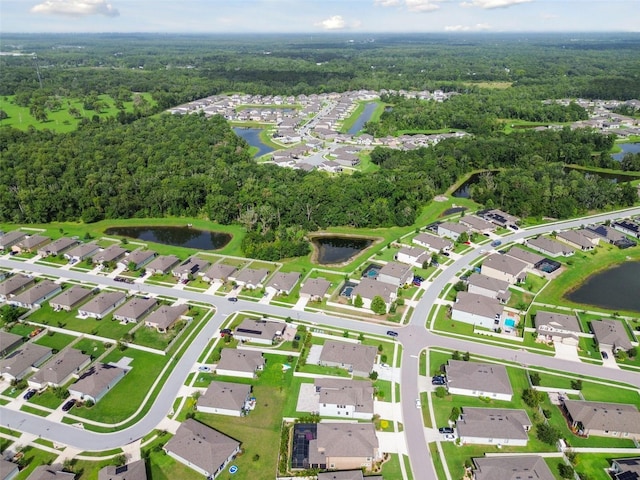 bird's eye view featuring a residential view, a water view, and a forest view