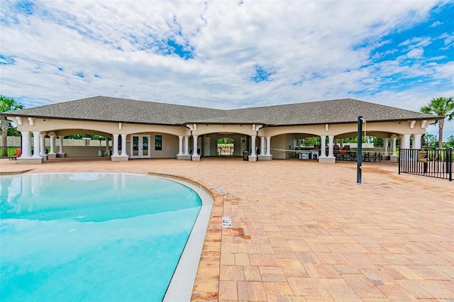 view of pool featuring a patio area, fence, a fenced in pool, and french doors