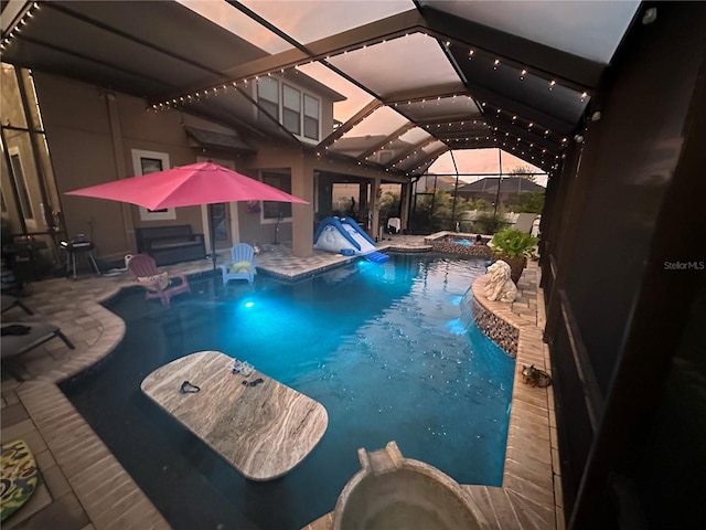 view of swimming pool with a lanai, an in ground hot tub, and a patio