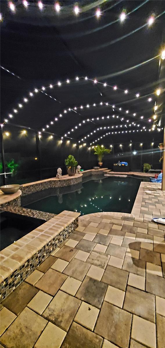 pool at night with a patio