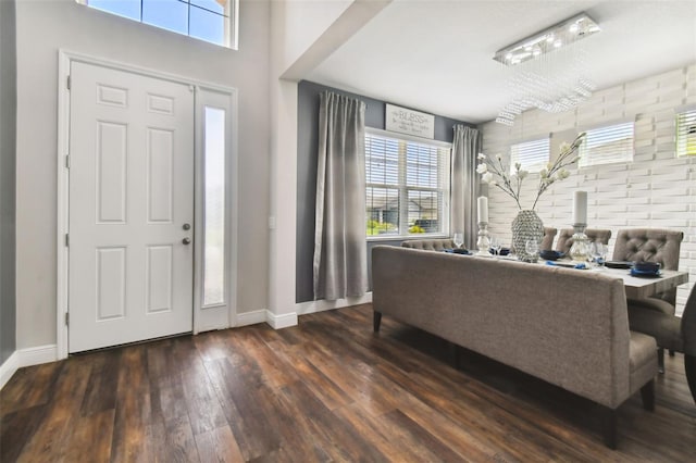 entryway with dark hardwood / wood-style flooring and an inviting chandelier