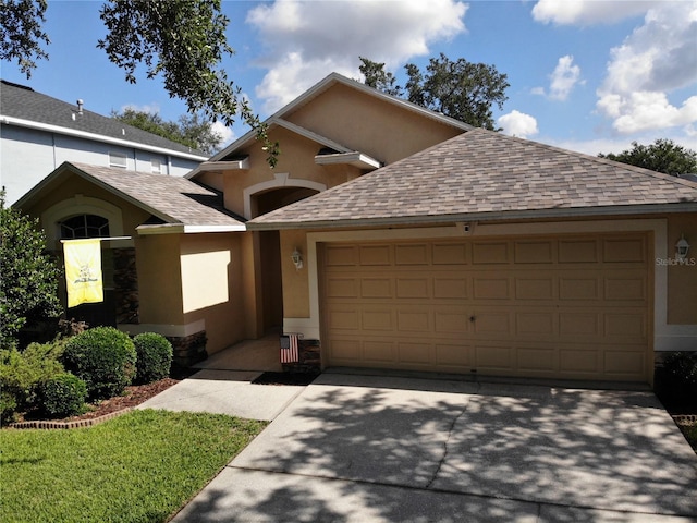 view of front of property with a garage, a shingled roof, concrete driveway, and stucco siding