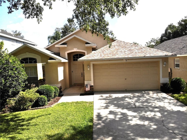 view of front of home featuring a front yard and a garage