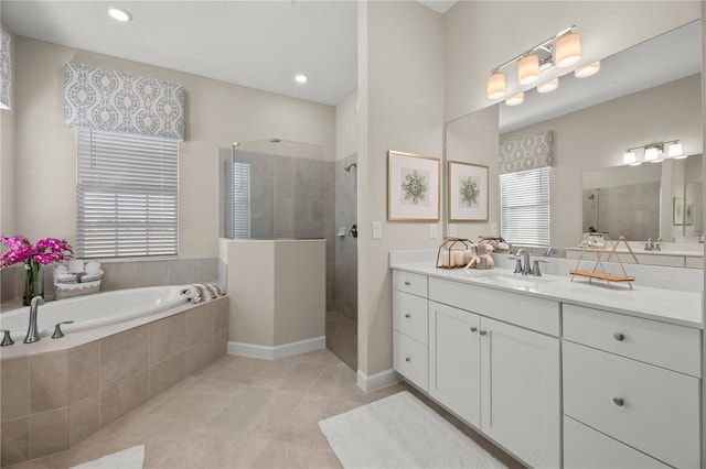 bathroom featuring vanity, tile patterned flooring, and plus walk in shower