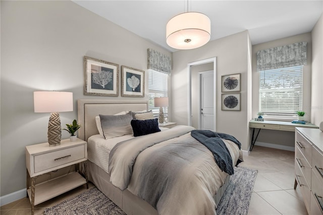 tiled bedroom featuring multiple windows